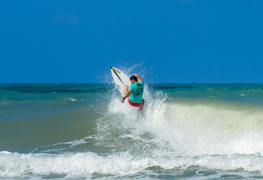 Surfer carving across a breaking wave in Bali, Indonesia, featured in this Bali surf guide.