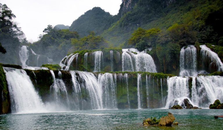 Ban Gioc Waterfalls in Cao Bang Province, Vietnam, cascading through lush limestone mountains Caption Description