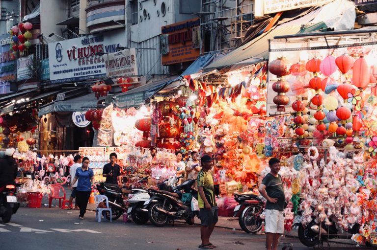 Colourful Vietnamese street market with lanterns, shops and local vendors in Ho Chi Minh City, Vietnam
