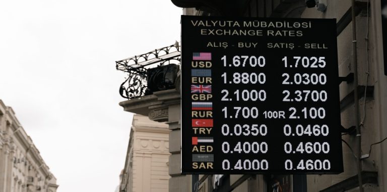 Currency exchange board displaying foreign exchange rates, illustrating currency exchange travel scams around the world.
