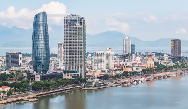 Skyline of Da Nang with the Han River, modern skyscrapers and surrounding mountains in central Vietnam