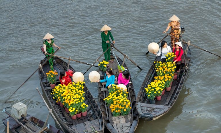 Traditional floating market in the Mekong Delta, one of the best things to do in Vietnam Caption Description