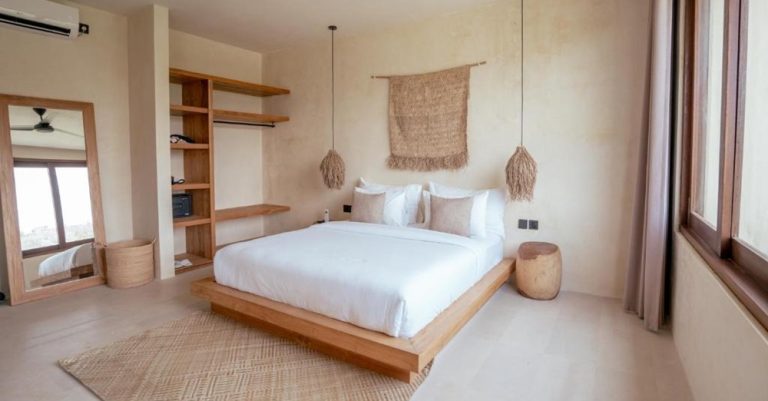 Elegant bedroom at Olea Villas Resort in Kuta Lombok featuring modern tropical design, king-size bed and minimalist décor.
