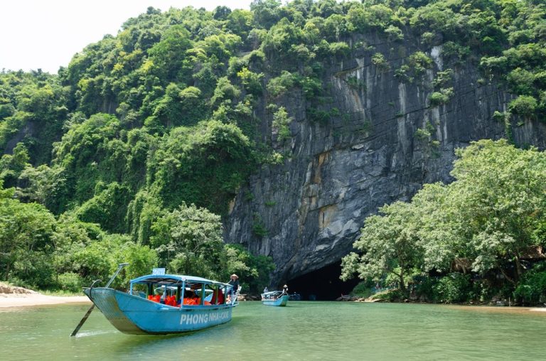 Boat entering Phong Nha Cave in Phong Nha-Ke Bang National Park, Vietnam Caption Description