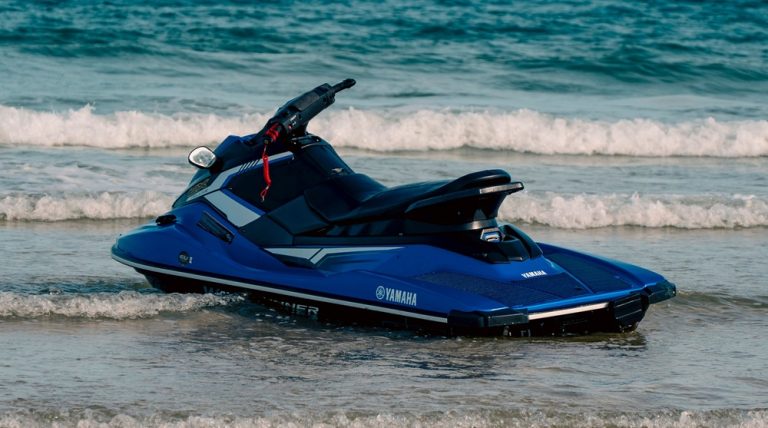 Jet ski on a beach illustrating rental travel scams around the world involving damage claims and hidden fees.