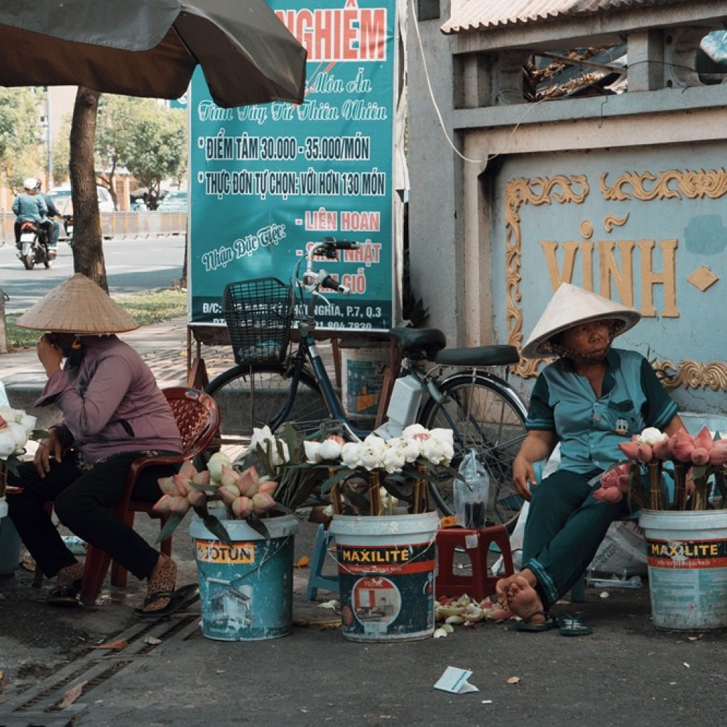 Street flower vendors in Ho Chi Minh City showcasing everyday local life during a trip filled with the best things to do in Vietnam