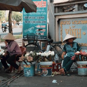 Street flower vendors in Ho Chi Minh City showcasing everyday local life during a trip filled with the best things to do in Vietnam