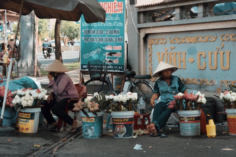 Street flower vendors in Ho Chi Minh City showcasing everyday local life during a trip filled with the best things to do in Vietnam