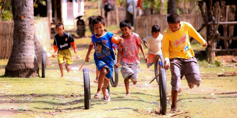 Children playing in a traditional Sasak village near Kuta Lombok, showcasing local culture and everyday life in Lombok, Indonesia.
