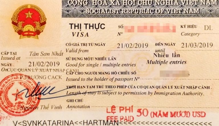 Vietnam tourist visa stamped in a passport showing multiple-entry permission and entry details