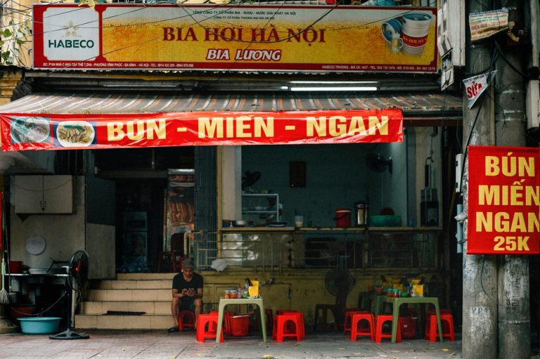 Local Hanoi restaurant serving Bia Hanoi beer and Vietnamese food on the street
