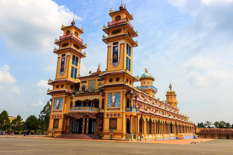 Colourful Cao Dai Temple with twin towers and ornate religious architecture in Tay Ninh, Vietnam