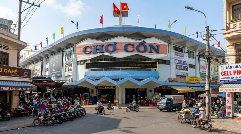 Exterior of Con Market with motorbikes and street vendors in central Da Nang