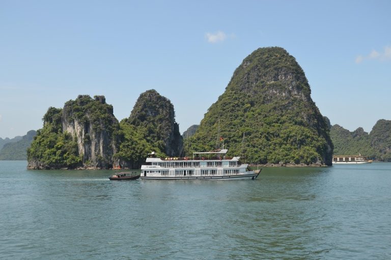Cruise ship sailing among the limestone islands of Ha Long Bay, one of the most iconic places to visit in Vietnam