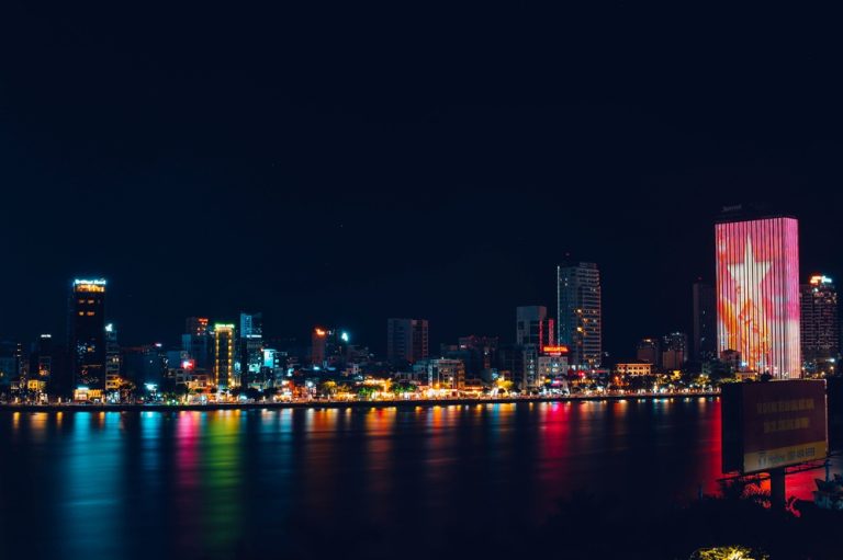 Da Nang skyline illuminated at night with colourful lights reflecting across the Han River