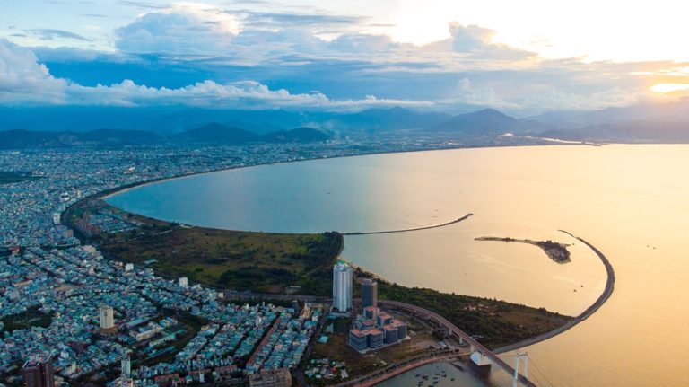 Aerial view of Da Nang coastline, city and mountains at sunset in Central Vietnam Caption: Description: