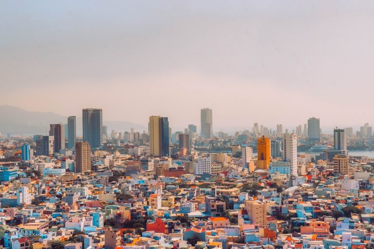 Panoramic view of Da Nang skyline with colorful buildings and mountains in Central Vietnam Caption: Description: