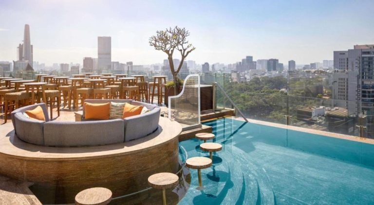 Rooftop infinity pool at Hotel des Arts Saigon MGallery Collection overlooking the Ho Chi Minh City skyline, offering a luxurious stay in the heart of District 3.