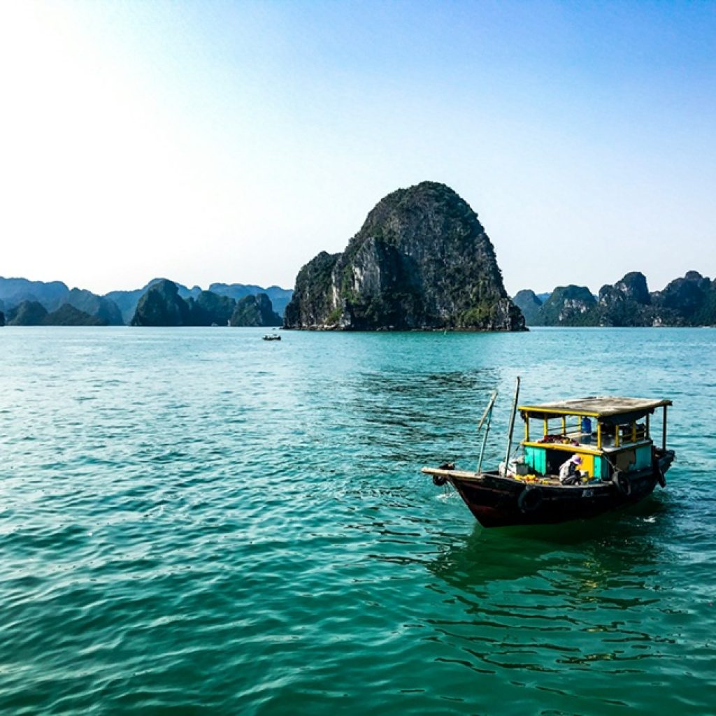 Traditional fishing boat on the emerald waters of Ha Long Bay, one of the highlights during the best time to visit Vietnam