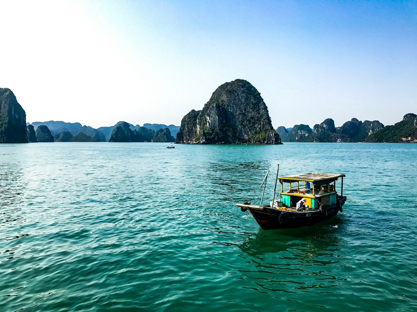 Traditional fishing boat on the emerald waters of Ha Long Bay, one of the highlights during the best time to visit Vietnam