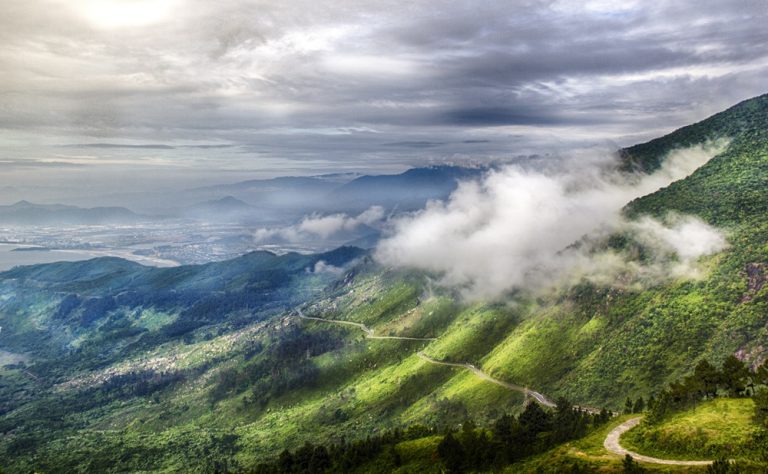 Hai Van Pass winding through green mountains and low clouds in Central Vietnam