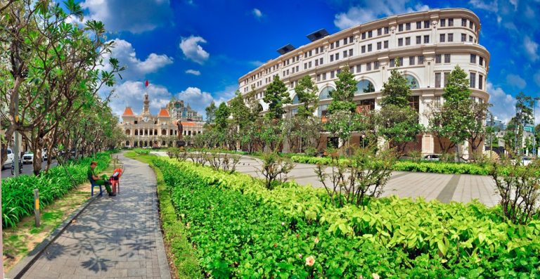 Landscaped gardens along Nguyen Hue Walking Street with Ho Chi Minh City Hall in the background