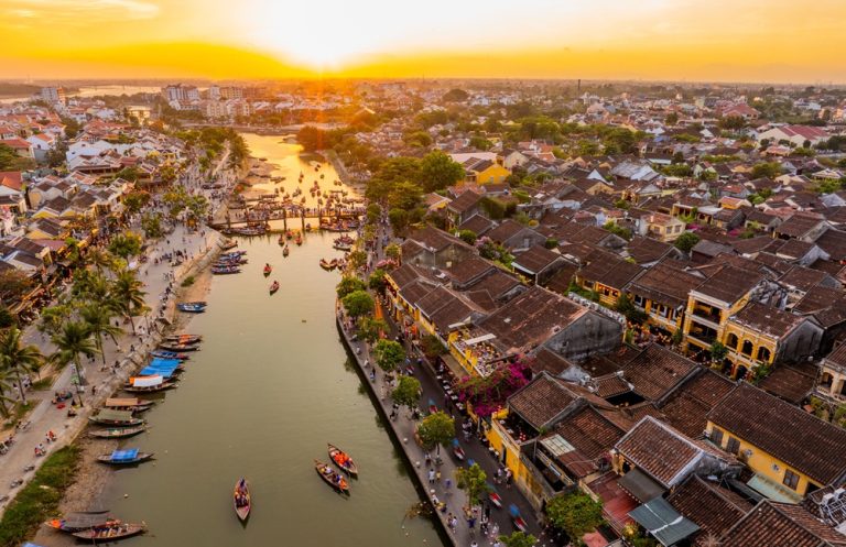 Aerial view of Hoi An Ancient Town at sunset with the Thu Bon River flowing through the historic centre