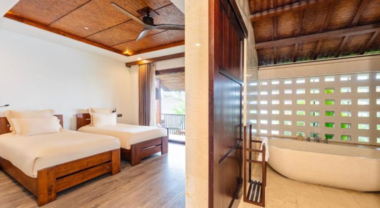 Spacious room with open-plan bathroom at Hoi An Eco Lodge & Spa surrounded by peaceful countryside