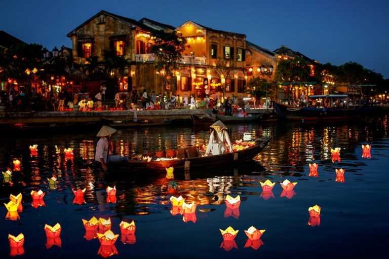 Things to do in Hoi An include taking a lantern boat ride on the Hoai River surrounded by colourful floating lanterns at night. Caption Description