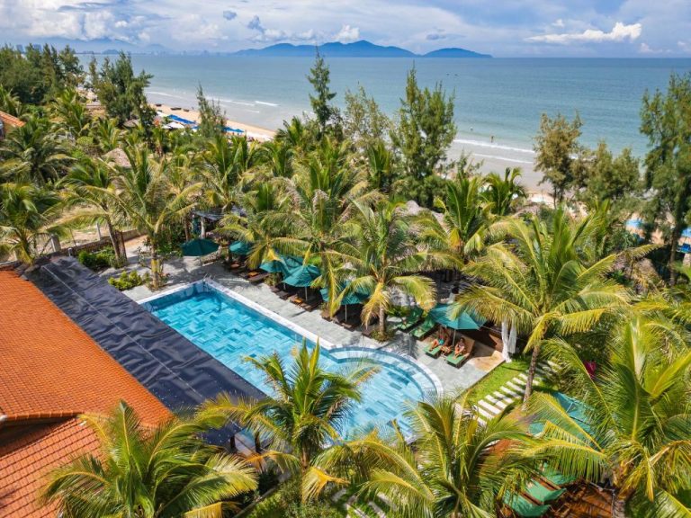 Hoianbang Beach Front Villa and Restaurant surrounded by palm trees beside An Bang Beach.