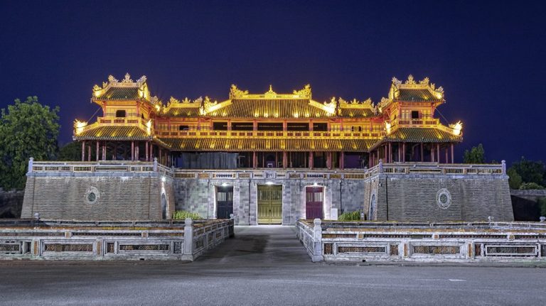 Illuminated historic gateway of the Imperial City in Hue, Vietnam at night