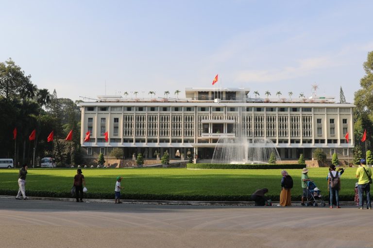 Independence Palace in Ho Chi Minh City with fountain, gardens and Vietnamese flag Caption: Description: