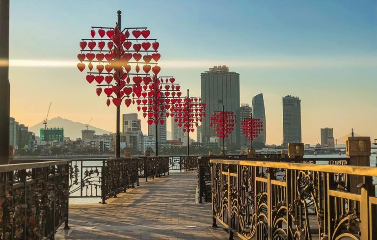 Love Lock Bridge decorated with red heart lanterns beside the Han River in Da Nang Caption: Description:
