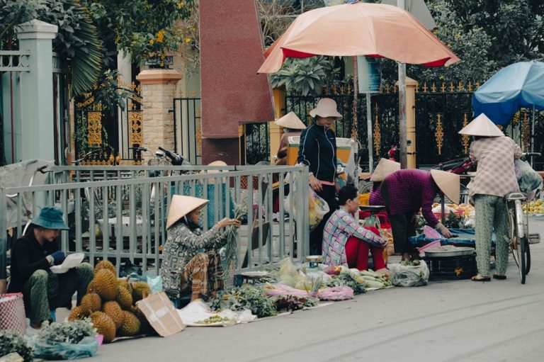 Local vendors selling fresh produce at a traditional street market in Vietnam