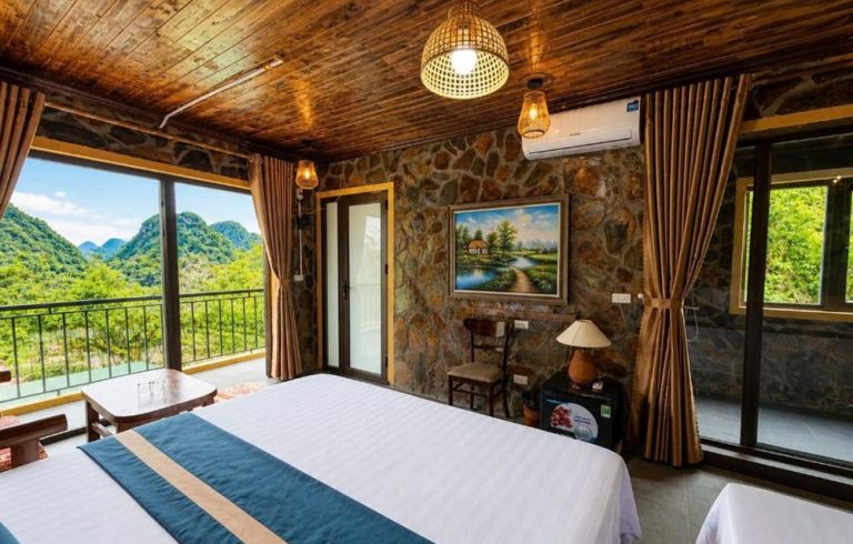 Guest room at Tam Coc Mountain Ecolodge with views of the limestone mountains in Ninh Binh Caption: Description: