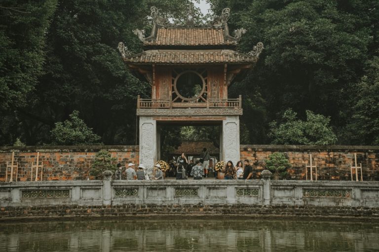 Traditional gateway at the Temple of Literature in Hanoi surrounded by trees and historic walls