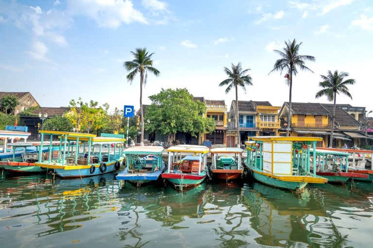 Traditional boats moored along the Thu Bon River in Hoi An, one of the most beautiful places to visit in Vietnam