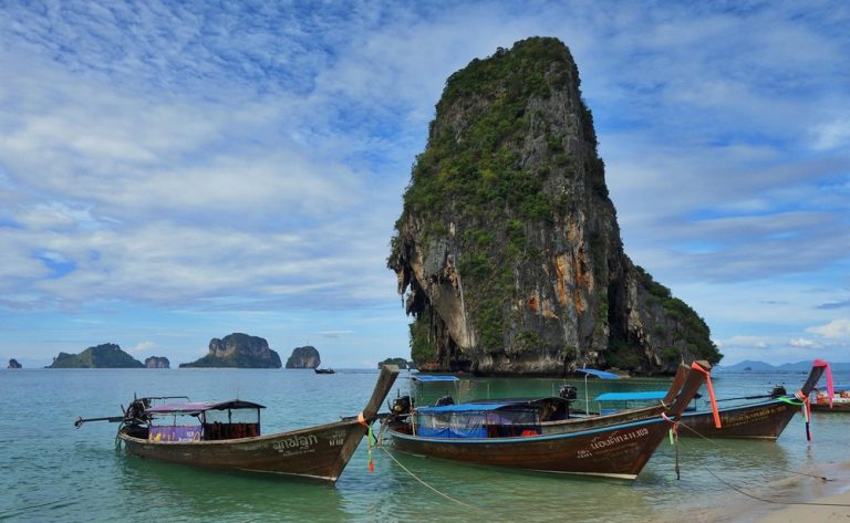 Things to do in Da Nang - traditional boats beside a limestone island on the Central Vietnam coast