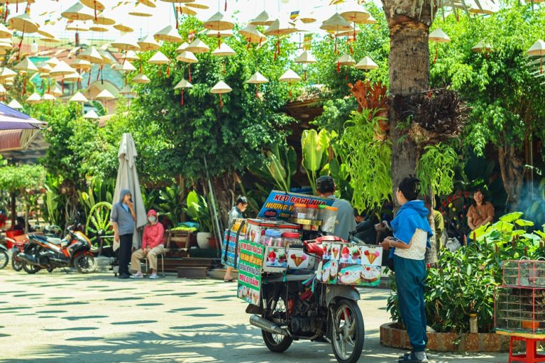 Traditional street food vendor in Vietnam, showcasing authentic local life and one of the everyday places to visit in Vietnam Caption Description