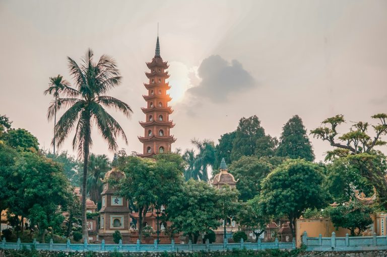 Tran Quoc Pagoda reflected in the peaceful surroundings of West Lake in Hanoi Vietnam