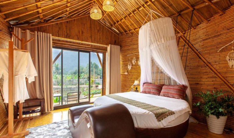 Bamboo guest room at Trang An Lamia Bungalow with a canopy bed and mountain views in Ninh Binh