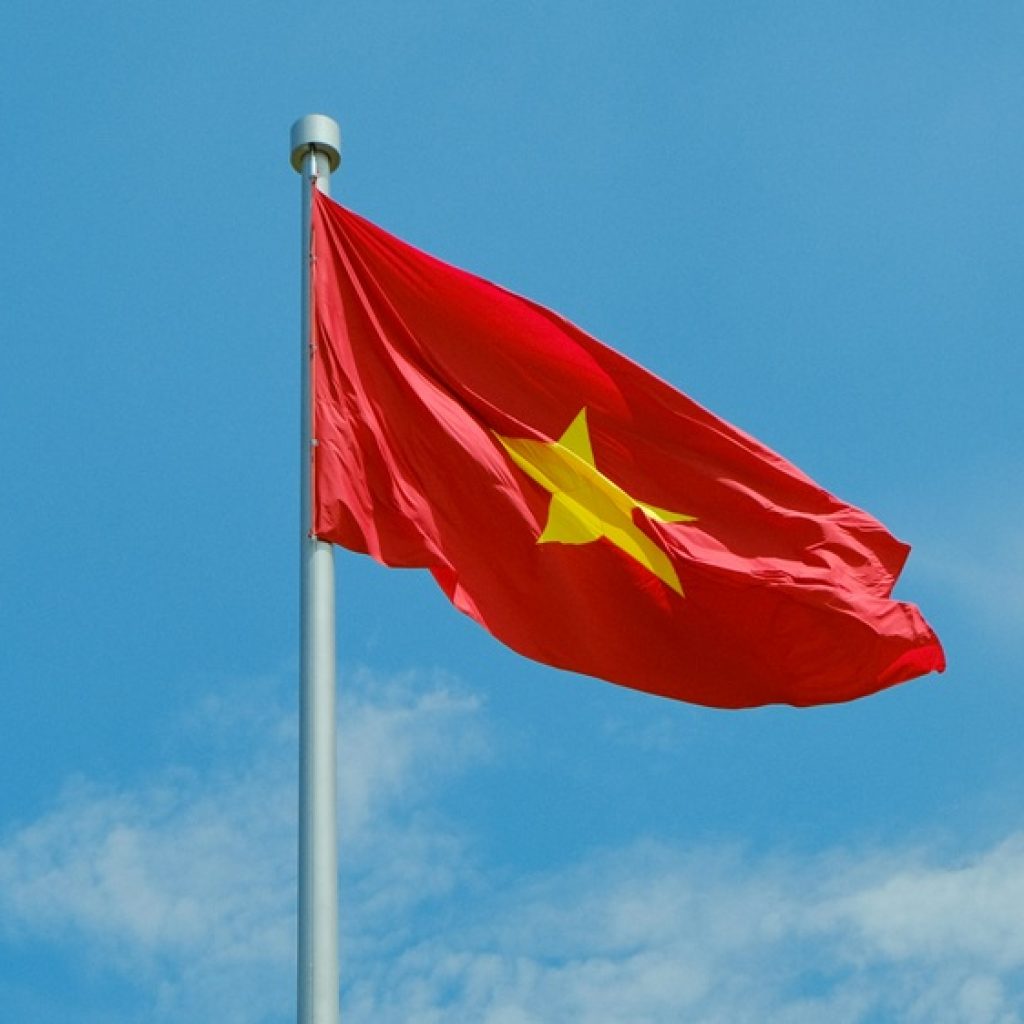 Vietnam Visa Guide - Vietnamese national flag flying against a clear blue sky