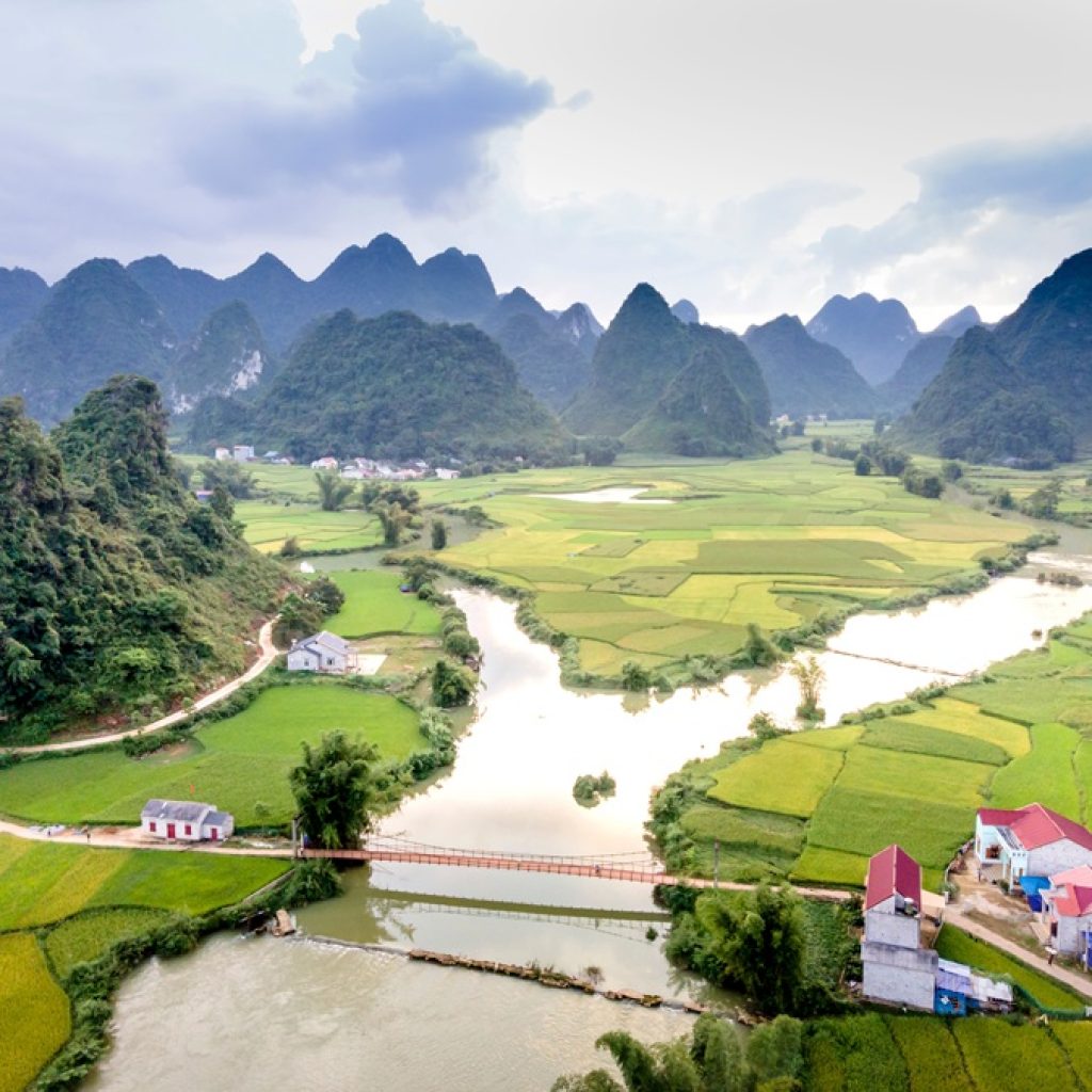 Vietnam travel budget - lush rice fields and dramatic limestone mountains in northern Vietnam