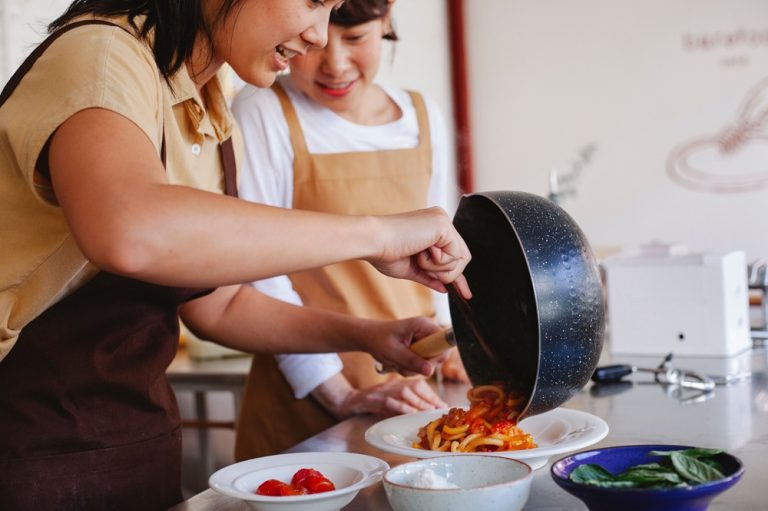 Travellers preparing a meal during a cooking class in Ho Chi Minh City