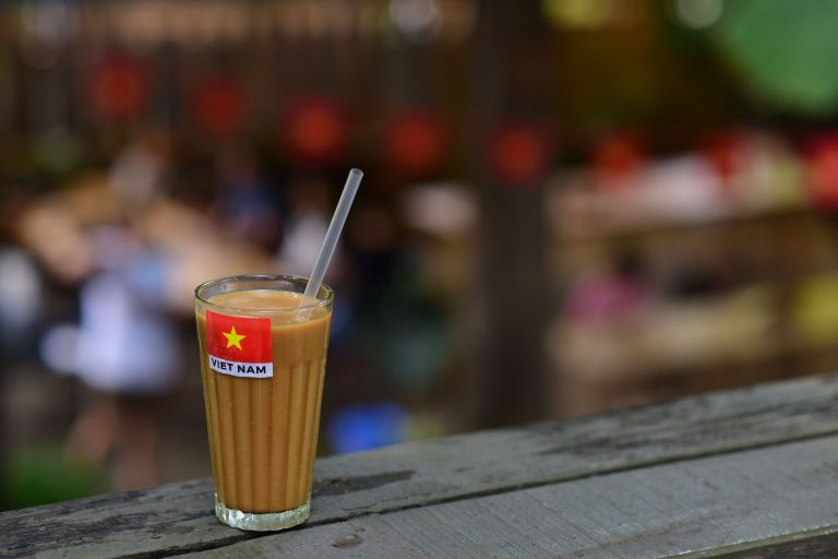 Glass of Vietnamese coffee with a Vietnam flag at a local café in Ho Chi Minh City