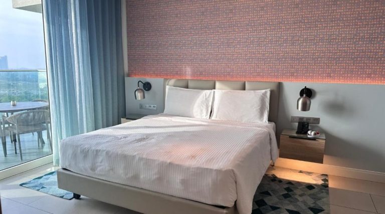 Modern guest room at Alma Resort Nha Trang with a double bed and private balcony