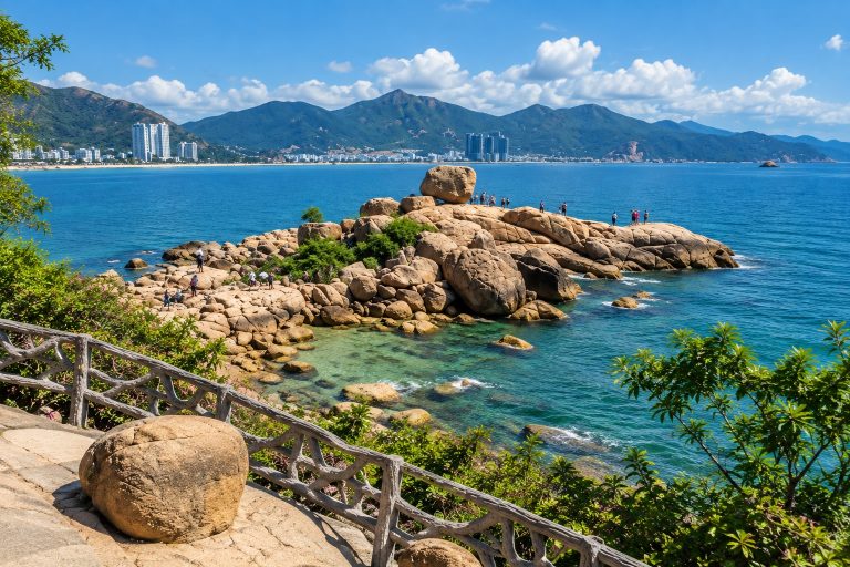 Hon Chong Promontory in Nha Trang with large granite rocks, turquoise sea and mountains along the coastline