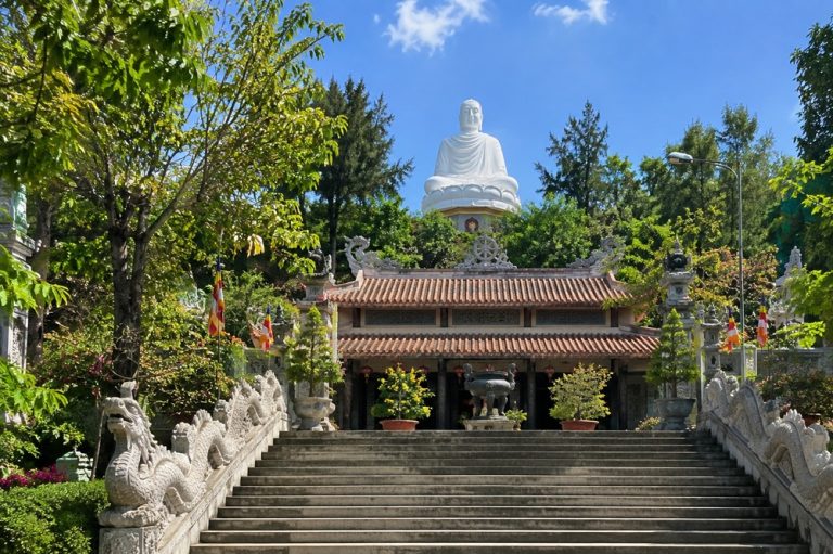 Long Son Pagoda in Nha Trang with its large white seated Buddha rising above the temple