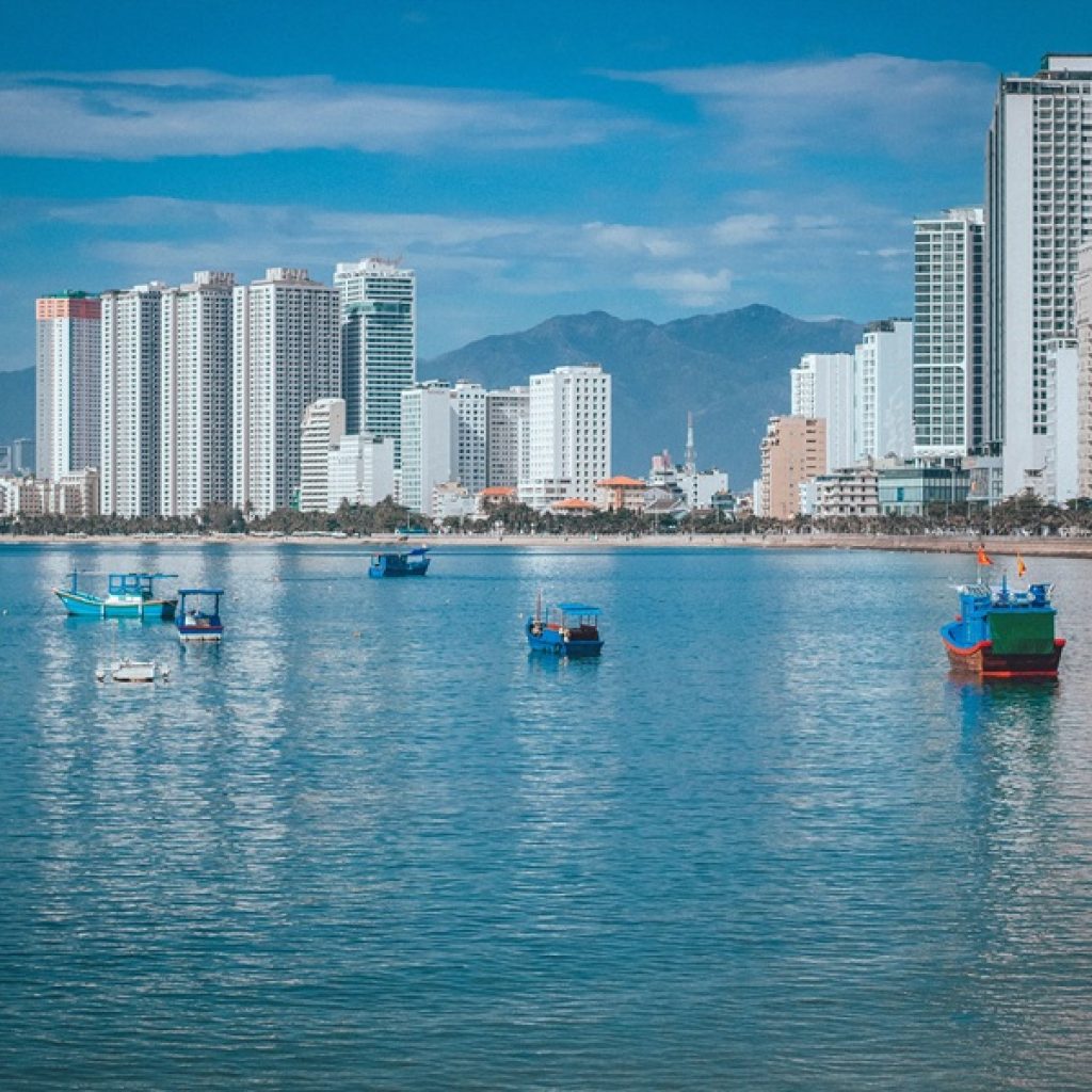 Things to do in Nha Trang - view across Nha Trang Bay with fishing boats and the beachfront skyline