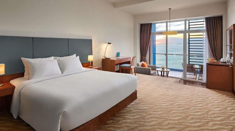 Junior suite at Novotel Nha Trang with a king-size bed, balcony and panoramic sea view